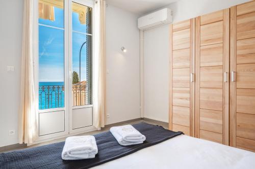 a bedroom with a bed and a large window at Le COQ Jean Jaurès - Garage XL-AC- Monaco Border in Roquebrune-Cap-Martin