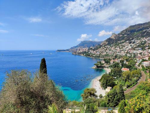 a view of a beach with a city and the ocean at Le COQ Symphonie - Parking - AC - WIFI in Menton