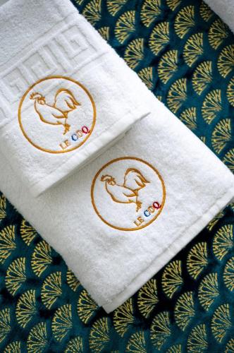 two napkins with birds on them on a table at Le COQ Splendide vue - Beautiful pool - Parking in Cap d'Ail