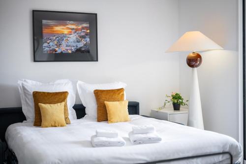 a bedroom with a bed with two towels on it at Le COQ Gabriel - Parking - Amazing view in Roquebrune-Cap-Martin