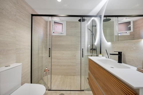 a bathroom with a shower and a toilet and a sink at Picasso 2 Royal in Marbella