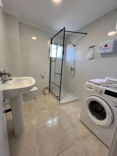 a bathroom with a washing machine and a sink at Safestay Calpe Seafront - Apartment Atlantico in Calpe
