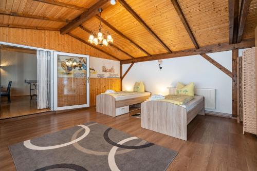 a large room with two beds and a table at Ferienhaus Nestwärme in Werchow