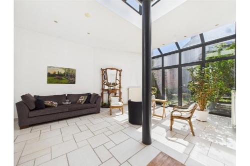 a living room with a couch and a chair at Maison de Maître in Liège