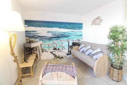 a living room with a view of the ocean at Gite La Paillotte, Ile De Ré in Sainte-Marie-de-Ré