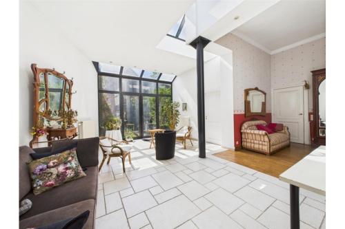 a living room with a couch and a table at Maison de Maître in Liège