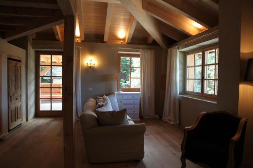 a living room with a couch and some windows at Hotel Alle Ciaspole in Fondo