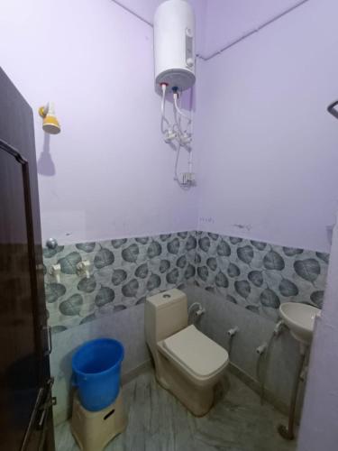 a bathroom with a toilet and a sink at Hotel Veeras in Palāi