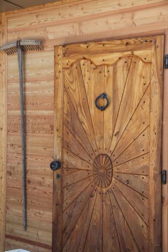 a large wooden door in a wooden cabin at Hotel Alle Ciaspole in Fondo