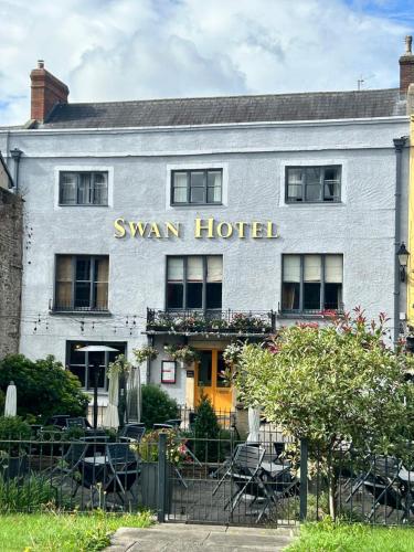 a building with a sign that reads swan hotel at The Swan Hotel, Wells, Somerset - The Coaching Inn Group in Wells