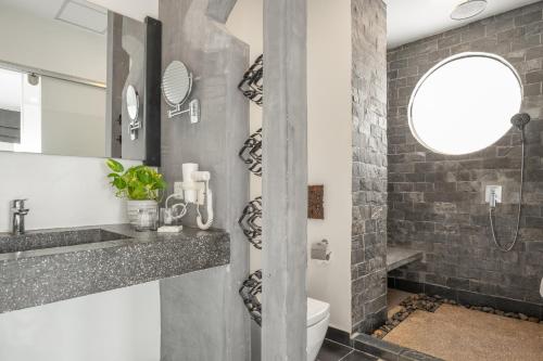 a bathroom with a sink and a toilet and a mirror at Central Suite Residence in Siem Reap