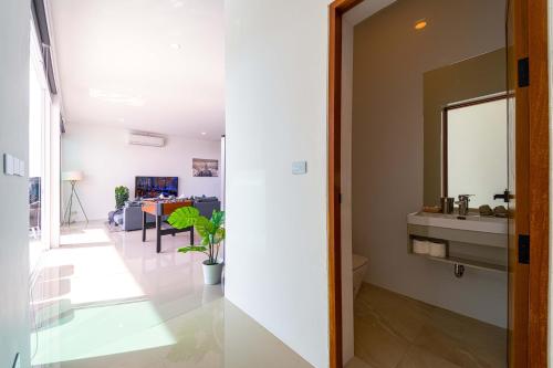 a bathroom with a mirror and a sink in a room at Harmony Villa 5 Bedroom Modern Pool Villa - KH-A7 in Khao Tao