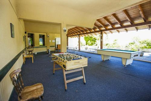 a room with several tables and a pool table at Ferienanlage La Gerbia in Cannobio