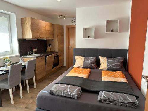 a small bedroom with a bed and a kitchen at Gut Maierlehen in Radstadt