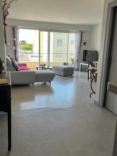a living room with a couch and a table at Rêver en bord de mer in Saint-Michel-Chef-Chef