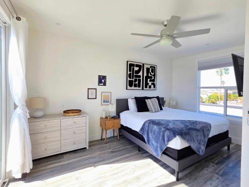 a bedroom with a bed and a ceiling fan at Park Blvd Paradise 303 king bed With a private Spa in San Diego