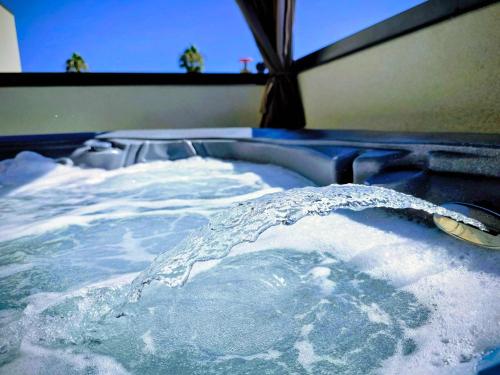 a bath tub filled with icy water with a spoon at Park Blvd Paradise 303 king bed With a private Spa in San Diego