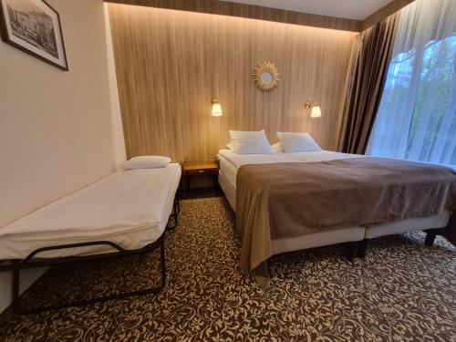 a hotel room with two beds and a window at Nėris Inn Terraces in Vilnius