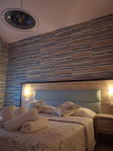 a bedroom with a bed with towels on it at Casa Michelangelo in Porto SantʼElpidio