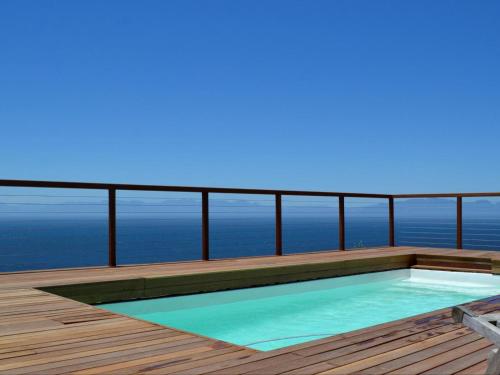 a swimming pool on the deck of a house at Oceans Drift Guest House & Self Catering in Simonʼs Town