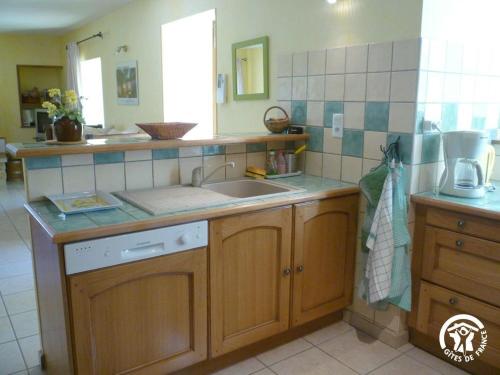 a kitchen with a sink and a counter at Gîte de caractère à Verlac in Verlac