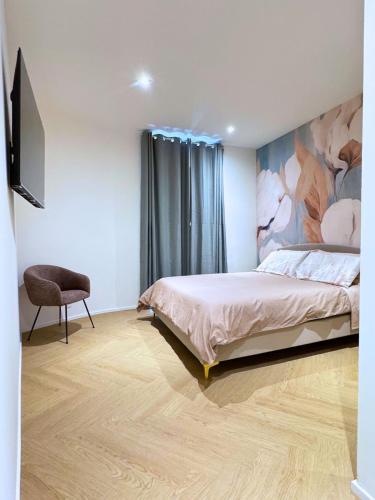 a bedroom with a bed and a painting on the wall at San Lorenzo Apartment in Giaveno