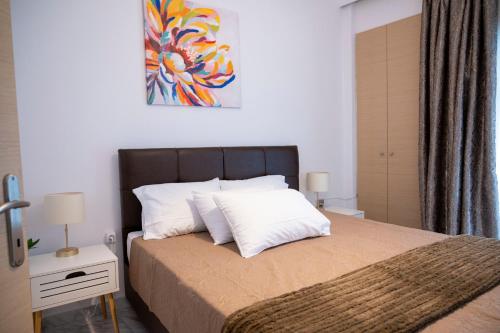 a bedroom with a large bed with white pillows at Lion's Nest in Mesochórion