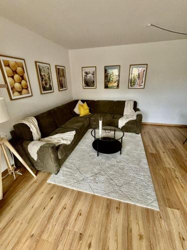 a living room with a couch and a table at Apartmenthaus Gilden 7 in Borken
