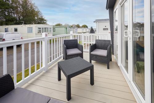 a balcony with two chairs and a table on it at Host & Stay - Grange in Morecambe
