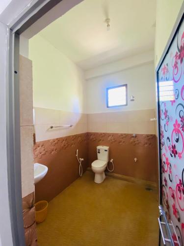 a bathroom with a toilet and a sink at Velora Resort in Anuradhapura