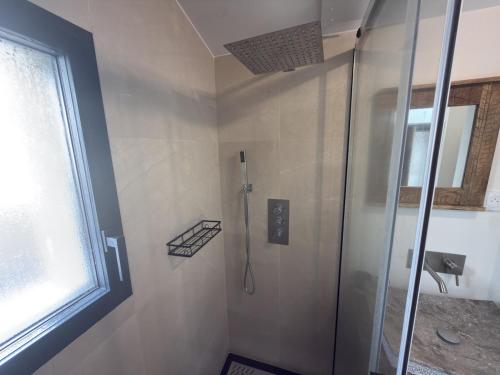 a shower stall in a bathroom with a window at Studio neuf - entrée indépendante - sans cuisine in Nantes