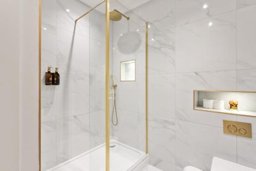 a shower with a glass door in a bathroom at Central Edinburgh Prime Luxury in Edinburgh