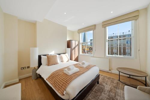a bedroom with a bed and a large window at Beautiful Victorian Townhouse in London