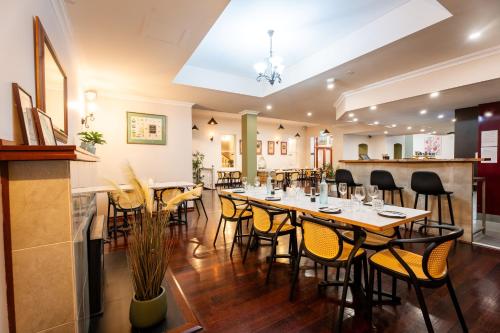 a dining room with a long table and chairs at The Burlington Hotel in Bunbury