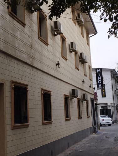 a building with windows on the side of it at Minor Hotel in Toshkent-Passajir Bekati