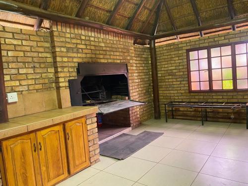- une cuisine en briques avec un four dans un mur de briques dans l'établissement The N1 Farm Place, à Pretoria