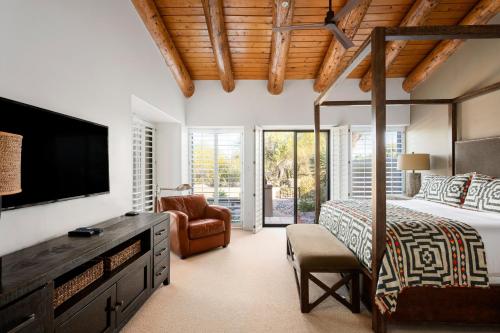 une chambre avec un lit et une télévision à écran plat dans l'établissement Exclusive Boulders Retreat near Downtown Cave Creek hiking scenic views., à Cave Creek