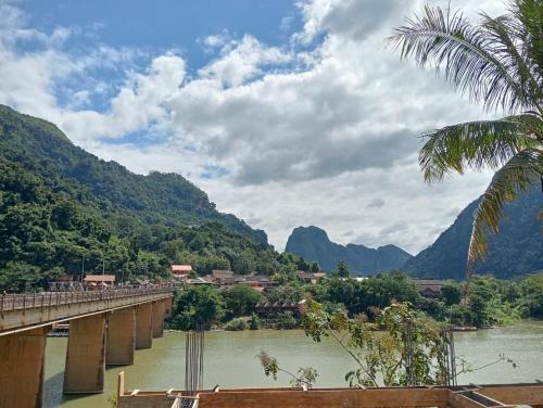 a bridge over a river with mountains in the background at Nongkhiaw view Guest house in Nongkhiaw