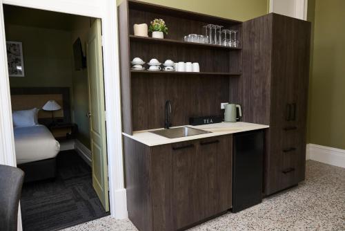 a kitchen with a sink and a bed in a room at The Burlington Hotel in Bunbury