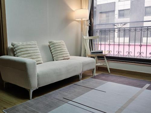 a living room with a couch and a window at 인천 청라3룸 인천공항 아시아드경기장 가족숙소 in So-yŏm