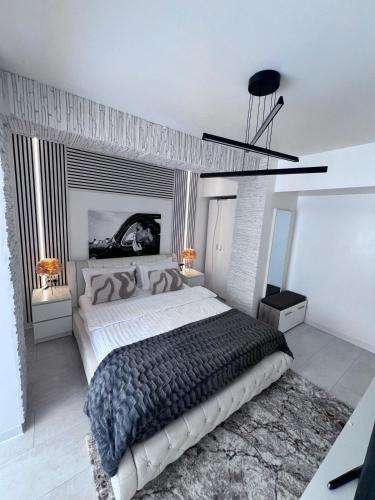 a bedroom with a large bed and a ceiling at Apartament Nedianu in Craiova