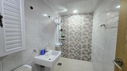 a white bathroom with a sink and a toilet at Rare House 4 in Incheon