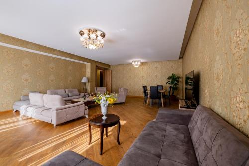 a living room with a couch and a table at Fabulous Apartment in the City Center in Tbilisi City