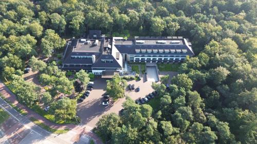 an aerial view of a building in the woods at Van der Valk Hotel Harderwijk op de Veluwe in Harderwijk