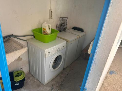 a washing machine with a green bowl on top of it at La Casa los Trancos, a 15 minutos de Cazorla in Peal de Becerro