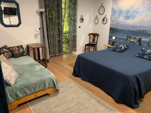 a bedroom with a bed and a couch and a window at Cookie home in Dolomieux