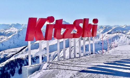 a sign on top of a snow covered mountain at KITZHORN EMOTIONS near skilift by Belle-Stay in Jochberg