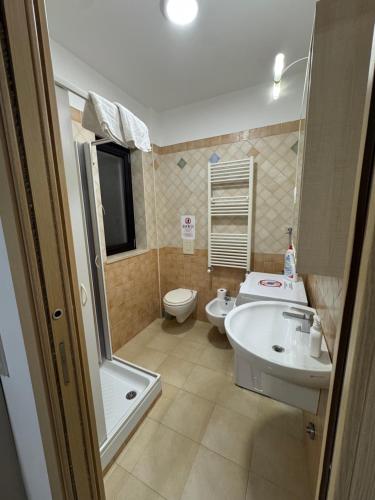 a bathroom with a sink and a toilet at Casa Vacanze Ginevra & Carlotta Villaggio RIVAZZURRA POLICORO in Policoro