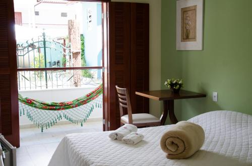 Ένα ή περισσότερα κρεβάτια σε δωμάτιο στο Vila Hibisco Pousada e Apart