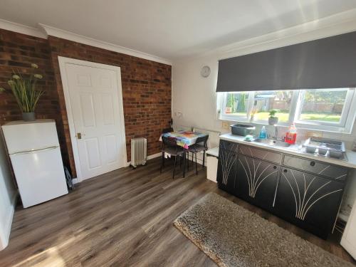 a kitchen with a sink and a counter top at Modern Apartment in Luton in Luton